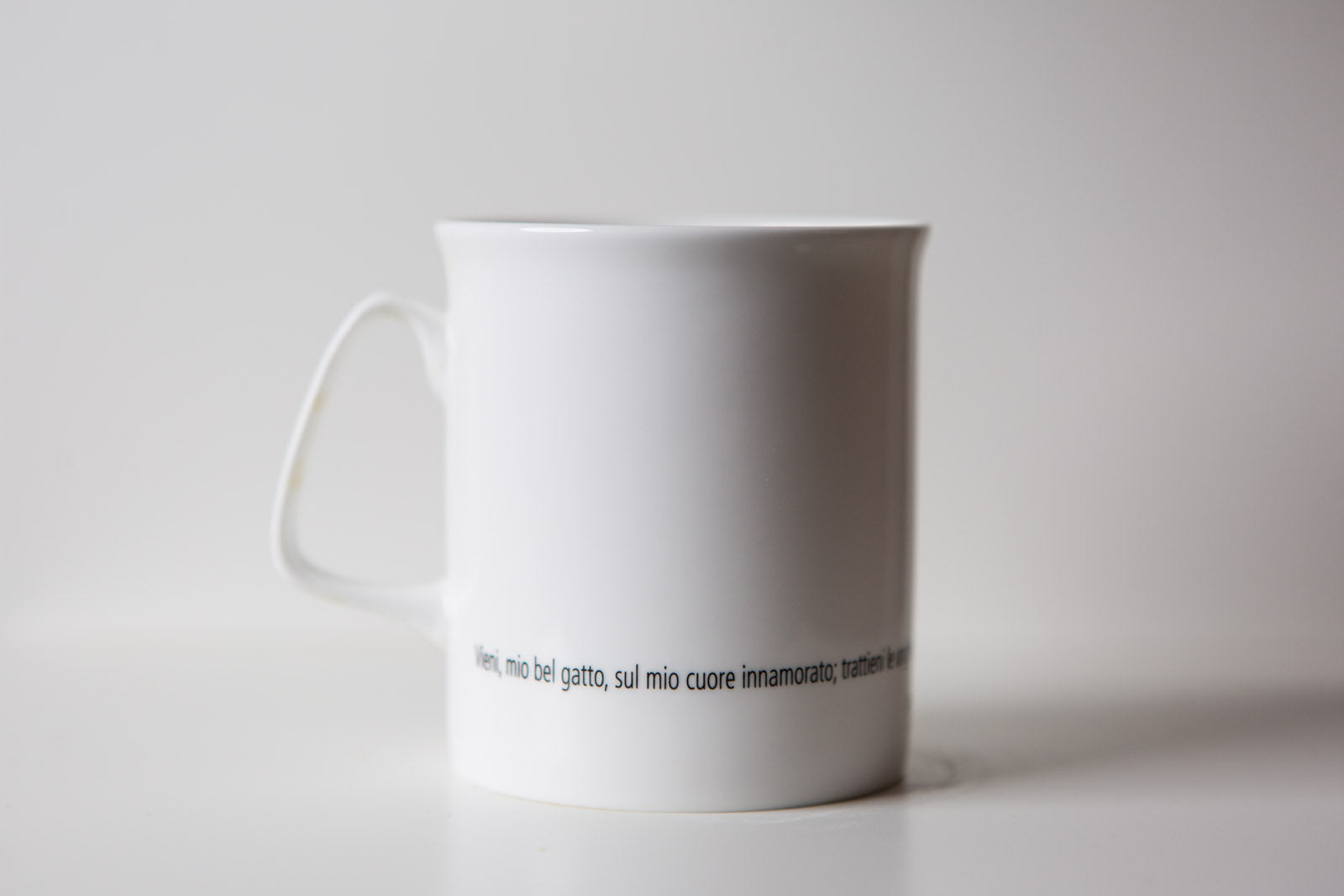 Tazza letteraria - Vieni, mio bel gatto, sul mio cuore innamorato; trattieni le unghie nelle zampe, e lasciami tuffare nei tuoi occhi in cui l’agata si mescola al metallo. Charles Baudelaire